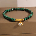 Women's white crystal bracelet with a high-rise lucky bamboo design on a wrist.