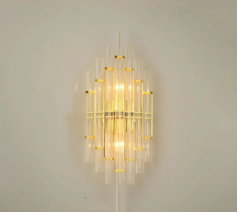 Modern crystal petal-shaped wall lamp in titanium gold finish mounted on a light-coloured wall.