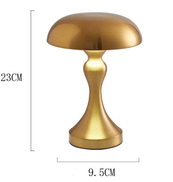 Metallic-finish USB charging desk lamp with touch control on a wooden desk.