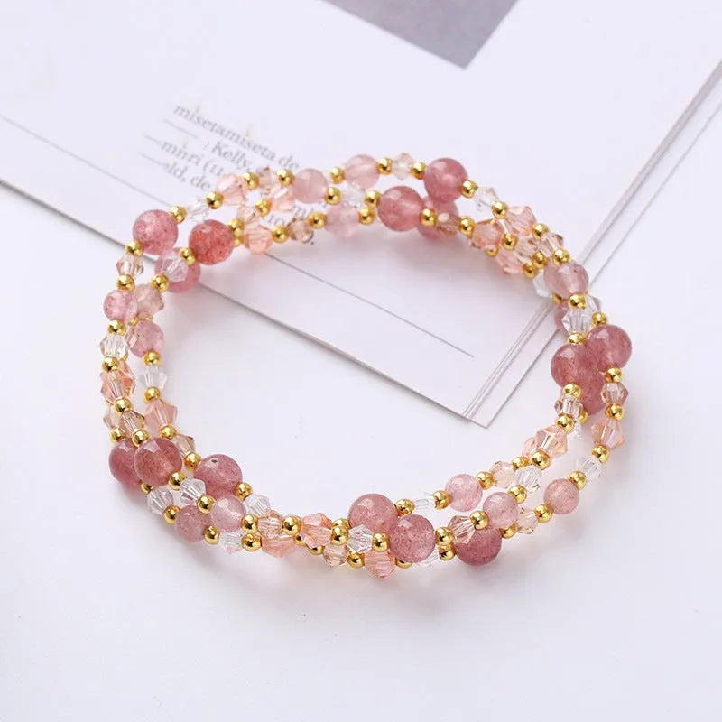 Women's adjustable bracelet with tourmaline, strawberry quartz, or amethyst crystal beads on a cord.