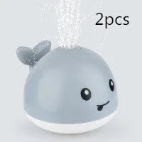 Automatic water-sensing whale bath toy with spray, lights, and music functions for baby bath time