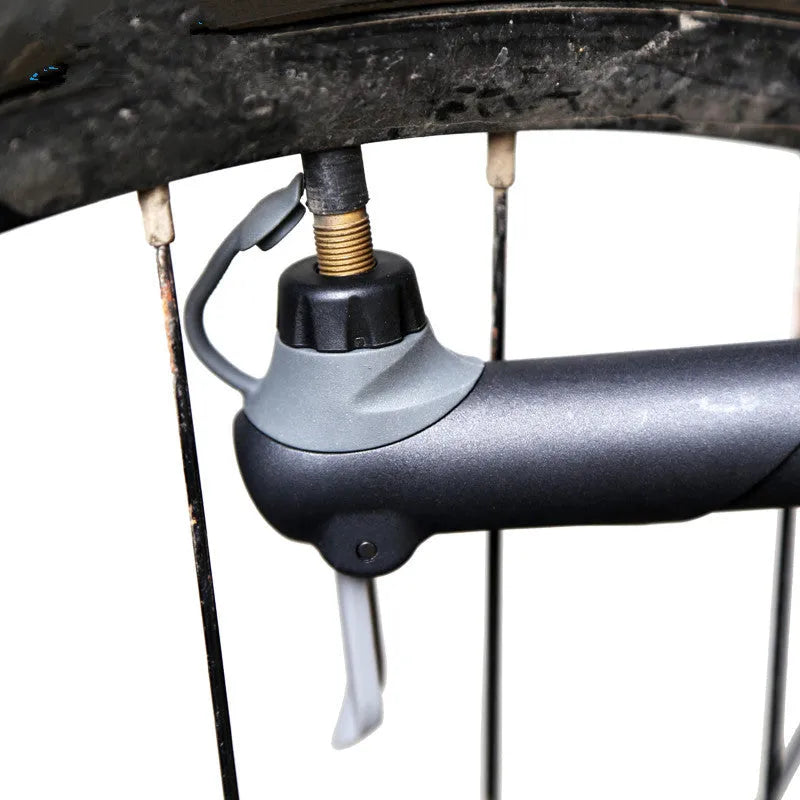 Black bicycle mini pump with round handle, 18cm length, 106g weight, on a wooden surface with bracket and mounting tape