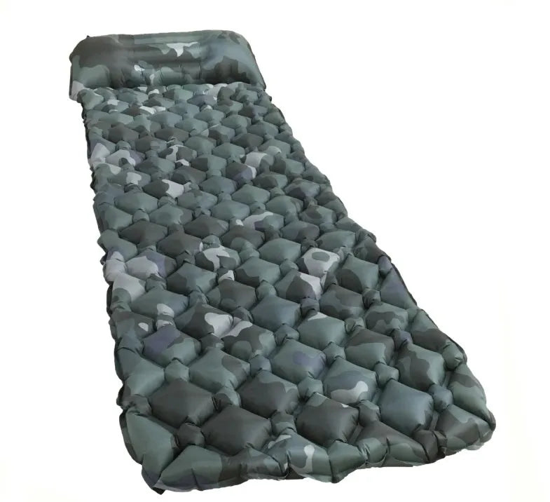 Blue camouflage inflatable camping sleeping pad made of diamond-pattern nylon on outdoor ground