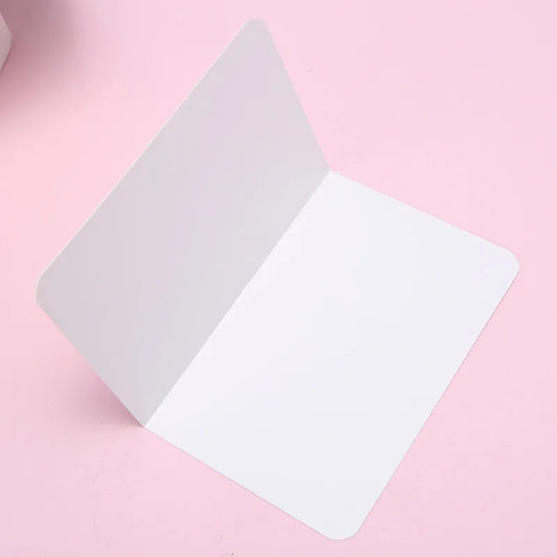 Blank folded kraft card 10x15cm in cowhide colour, packed in a stack of 100 for stationery use