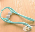 Blue plastic swan-shaped neck massager with hand roller and adjustable stand on a white background