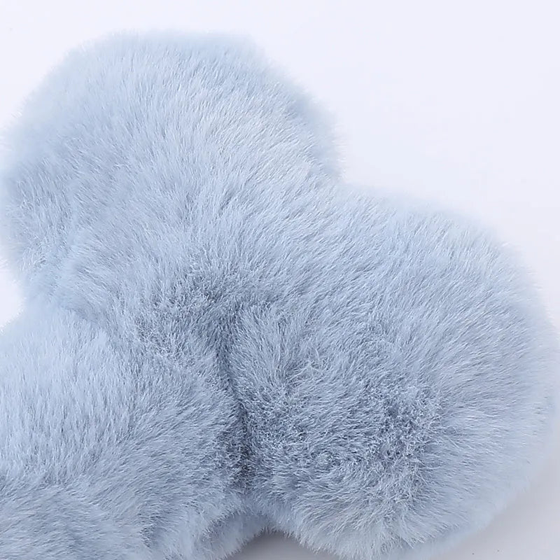 Blue Love Bone shaped plush dog toy with a squeaker on a white background.