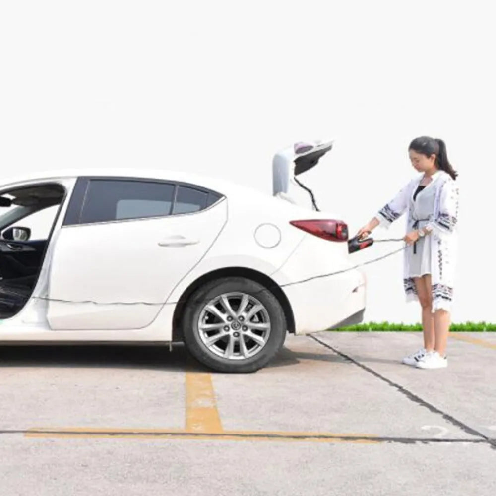 Handheld 120W car vacuum cleaner with brush and long nozzle, black wired model, on car seat