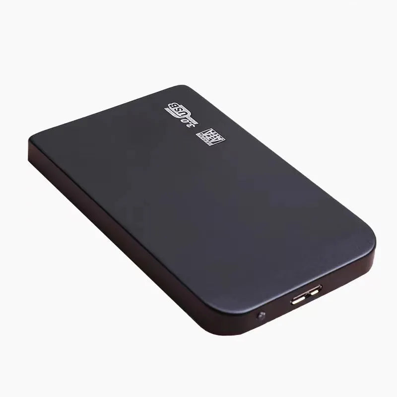 Silver metal external solid state drive with USB 3.0 cable on a desk.