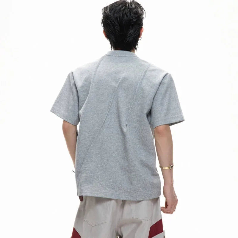 Man wearing a black cotton t-shirt with textured 3D pleating and a round neck