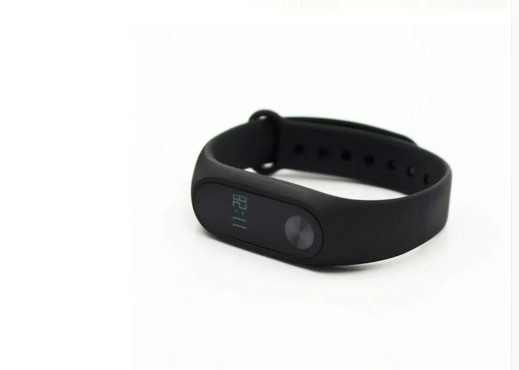 Black Xiaomi Mi Band 2 fitness tracker on wrist showing OLED display with heart rate reading