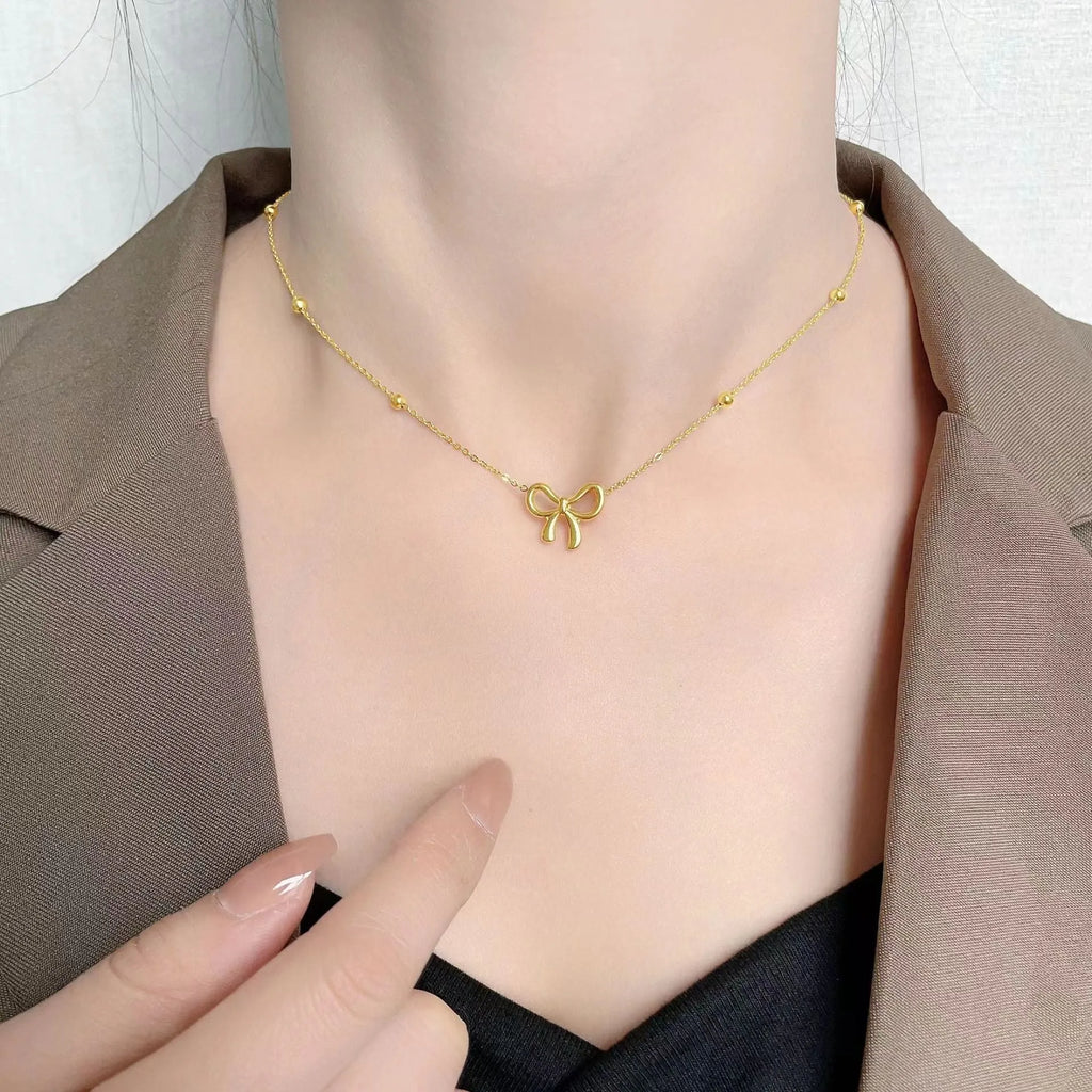 Gold titanium steel bow necklace with cross chain style for women