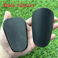 Extra small mini football shin guards measuring 8x5cm in black and white colours