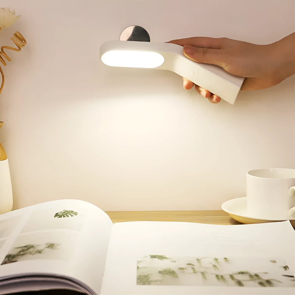 Simple white LED desk lamp with touch control and USB cable on a modern desk