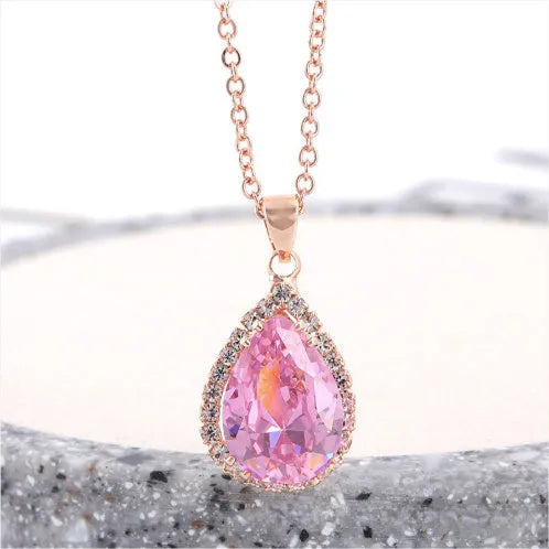 Rose gold geometric drop necklace with rhinestone details in pink colour option