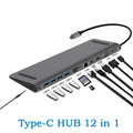 Grey aluminium alloy 12-in-1 Type-C hub with HDMI, VGA, USB 3.0, Ethernet, and PD ports on a desk