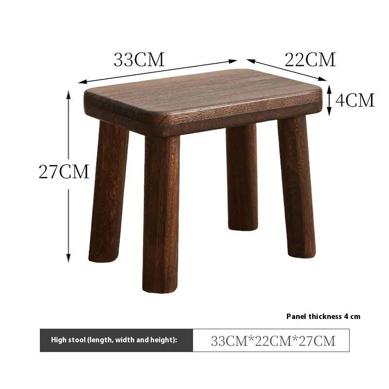 Solid wood shoe changing stool with a distressed rustic finish and sturdy bracket legs.