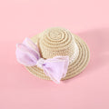 Woven straw hat for a cat with a large central pearl bow, available in blue, pink, purple, and white.