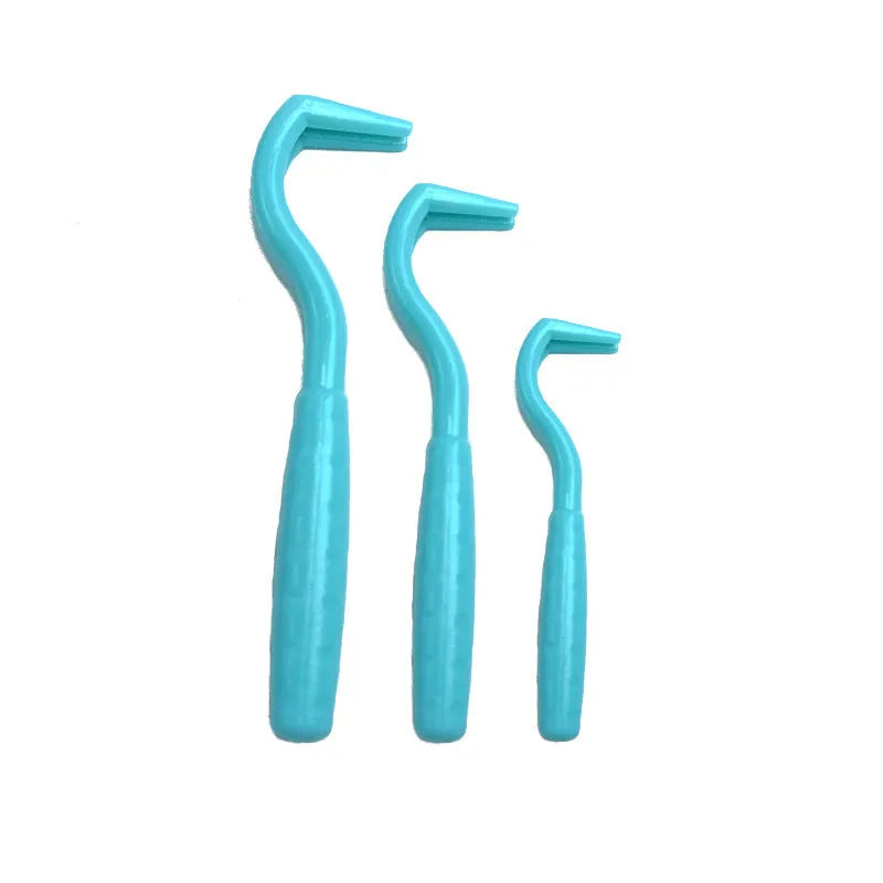 Set of three coloured plastic tick hook removal tools for dogs on a white background.