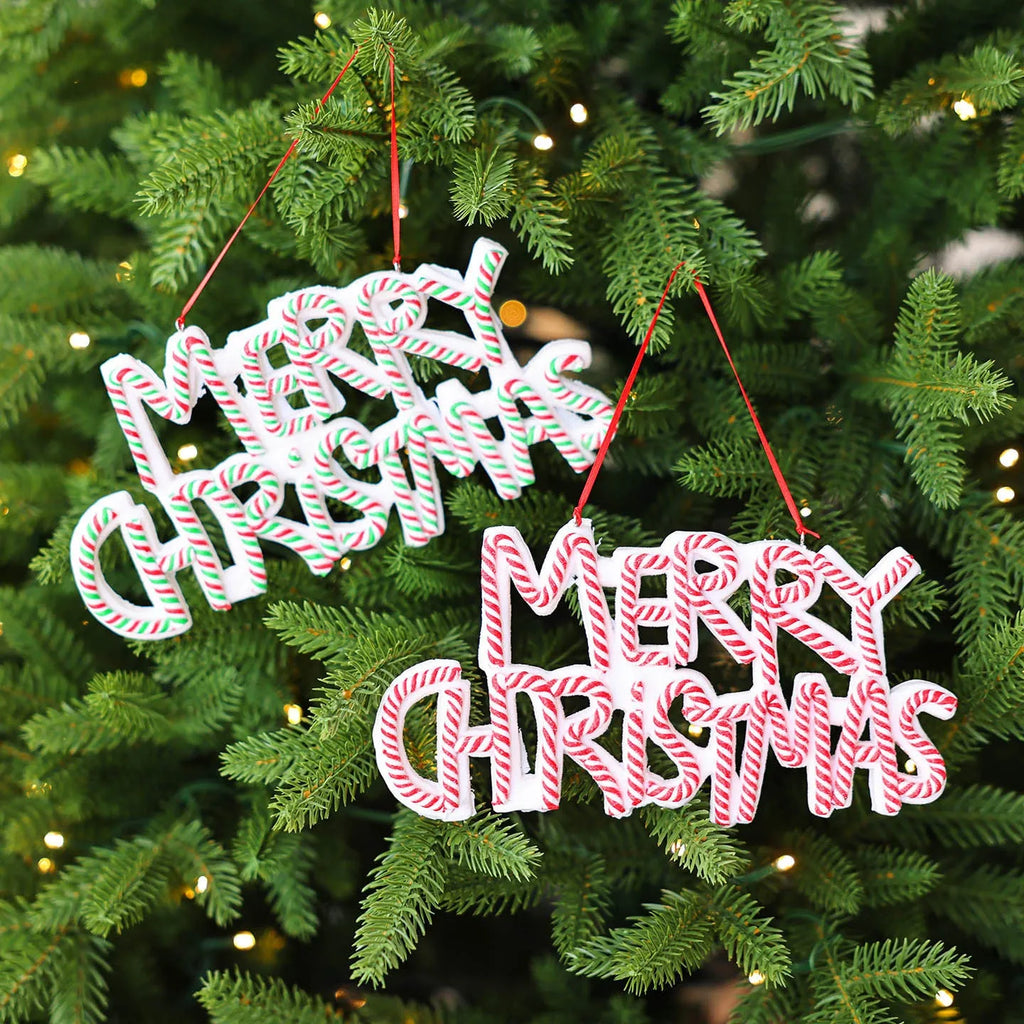 Merry Christmas letter plate polymer clay tree ornament in red, white and green plastic hanging on a tree branch