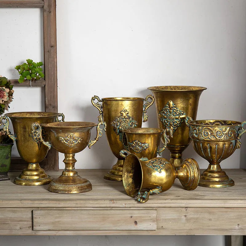 Metal decorative vase with black and gold finish, modern simplicity design on a tabletop