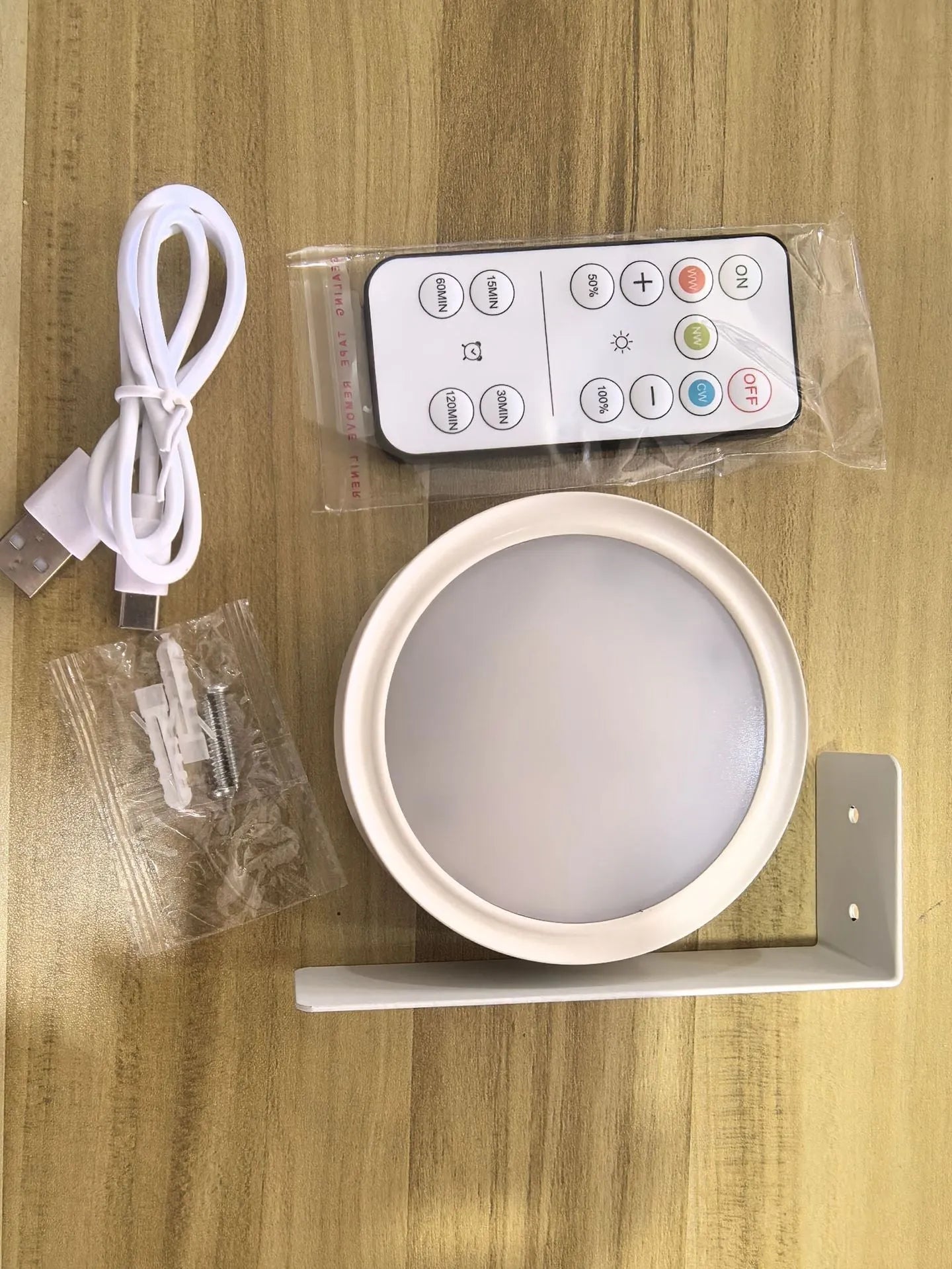 Wireless LED painting lamp with a magnetic mounting belt and remote control in black finish.