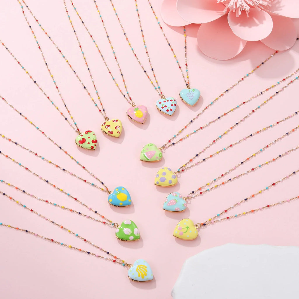 Gold-plated stainless steel necklace with heart-shaped fruit pendant on an adjustable chain.