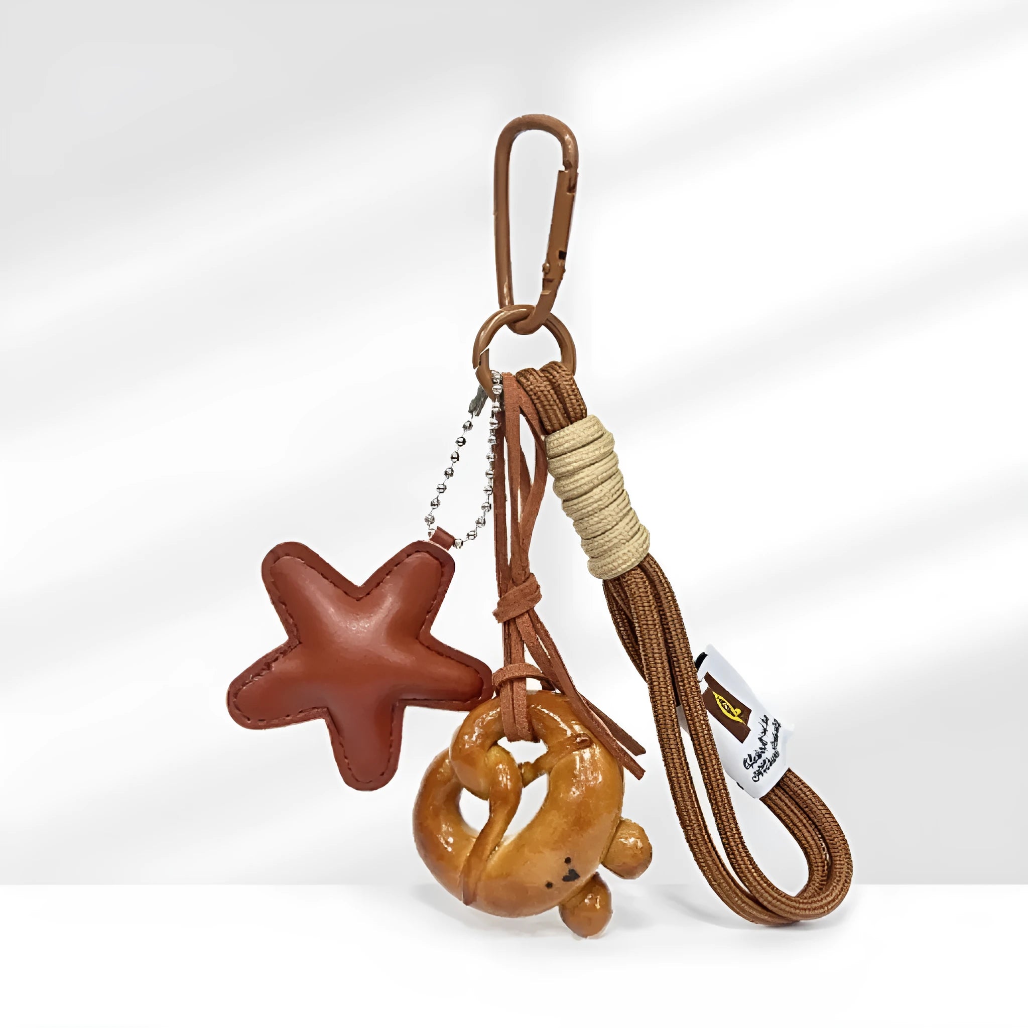 Handmade soda bread handbag pendant ornament with brown carrying strap on a bag.