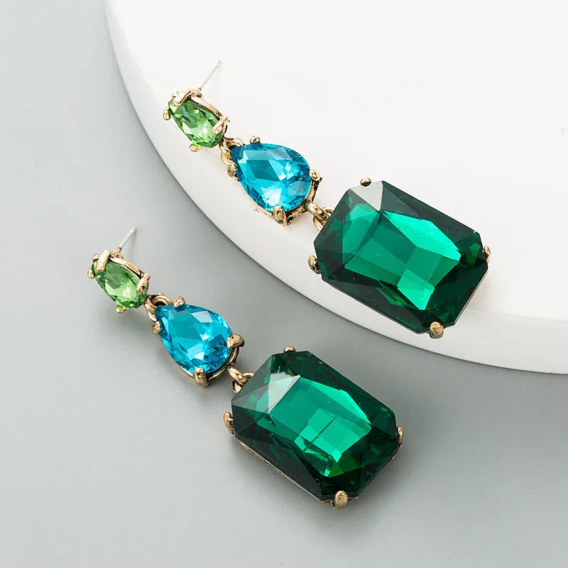 Pair of minimalist rhinestone geometric earrings in round shape, available in purple, green, or brown, European American fashion style.