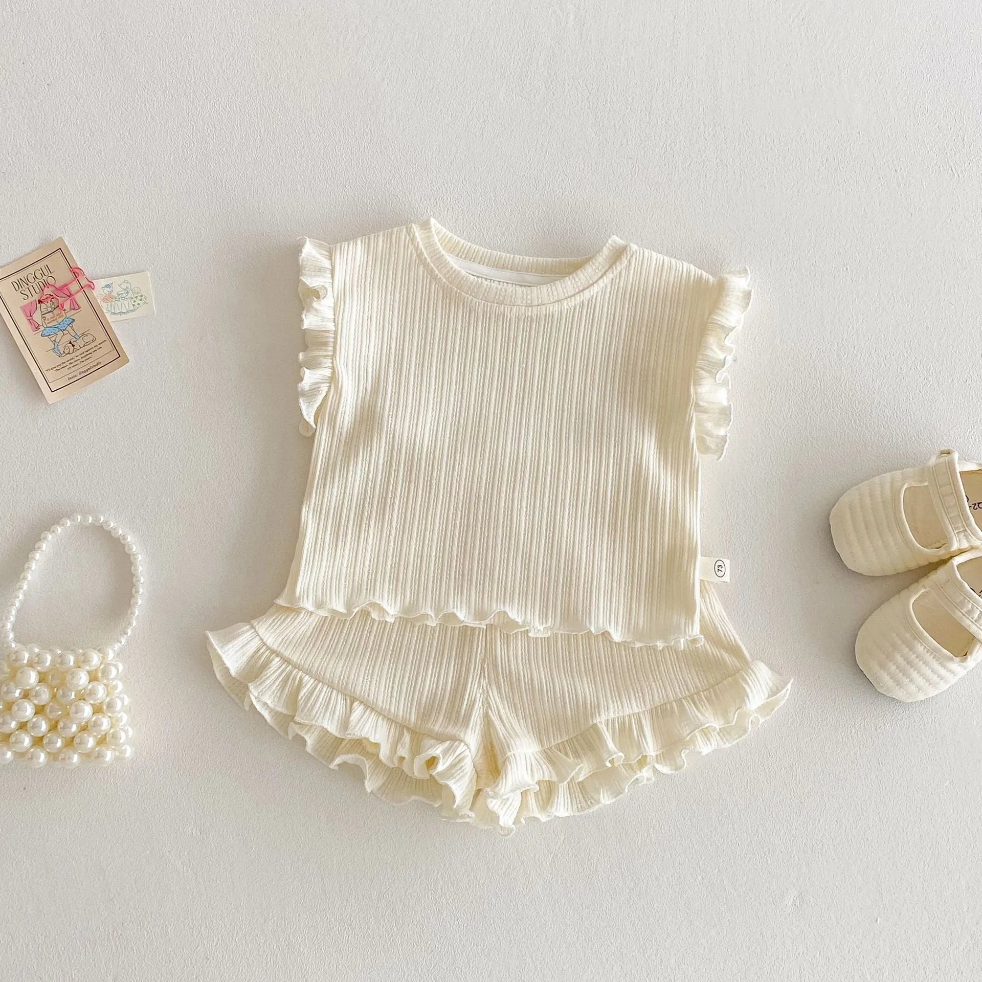 Baby girl two-piece cotton shorts set in light beige with wooden ear vest top and matching shorts