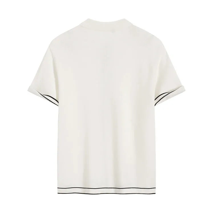 White women's short sleeve cardigan with dark contrast colour lapels on a hanger.