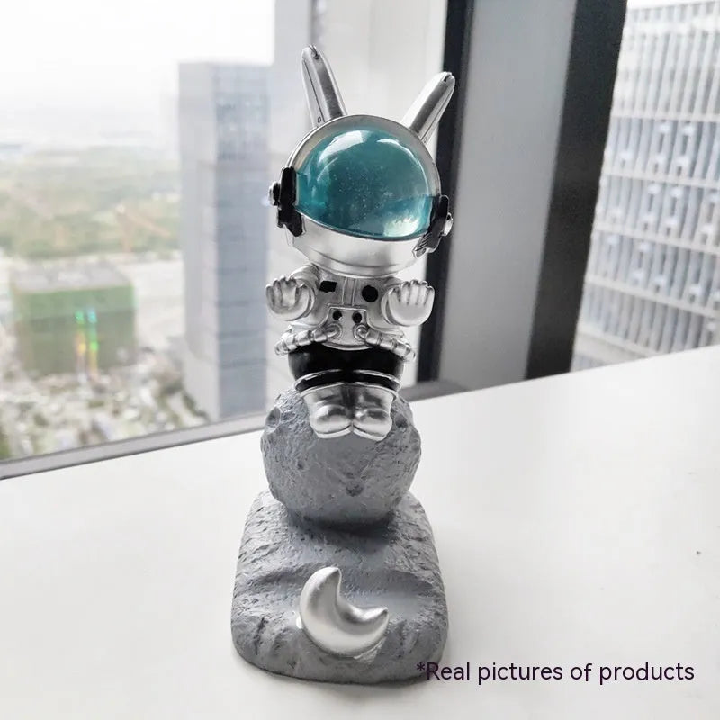 Space rabbit resin mobile phone stand in pink for desktop use