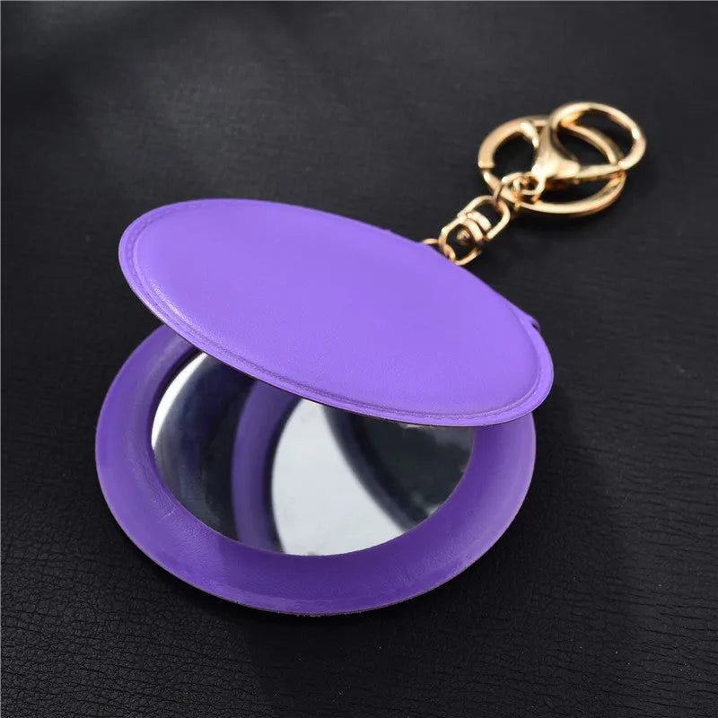Compact round ladies leather makeup mirror with 8cm diameter glass surface and golden buckle