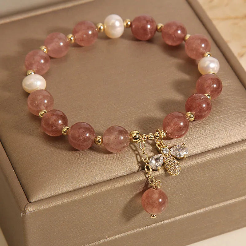 Women's bracelet with freshwater pearls, strawberry quartz stones, zircon accents and alloy bee charm