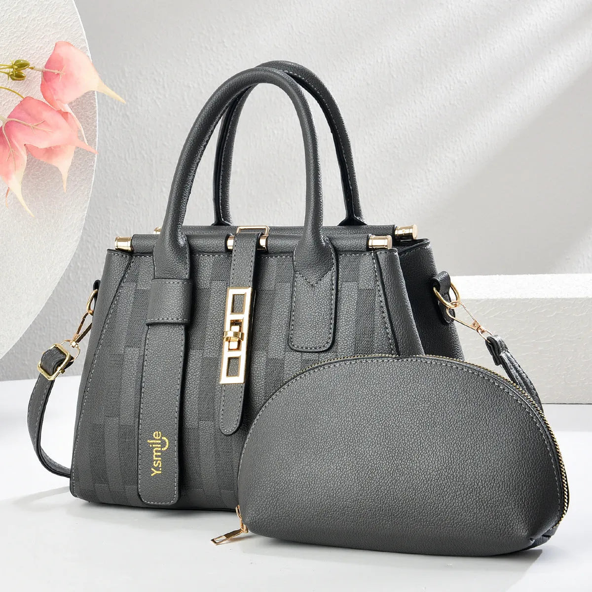 Round black PU handbag with crossbody strap shown alongside light khaki and purplish red colour options