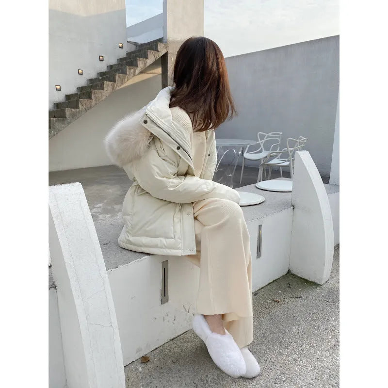 Women's high-waist knitted wide-leg trousers in a cream white colour, showcasing the straight-leg mopping style.