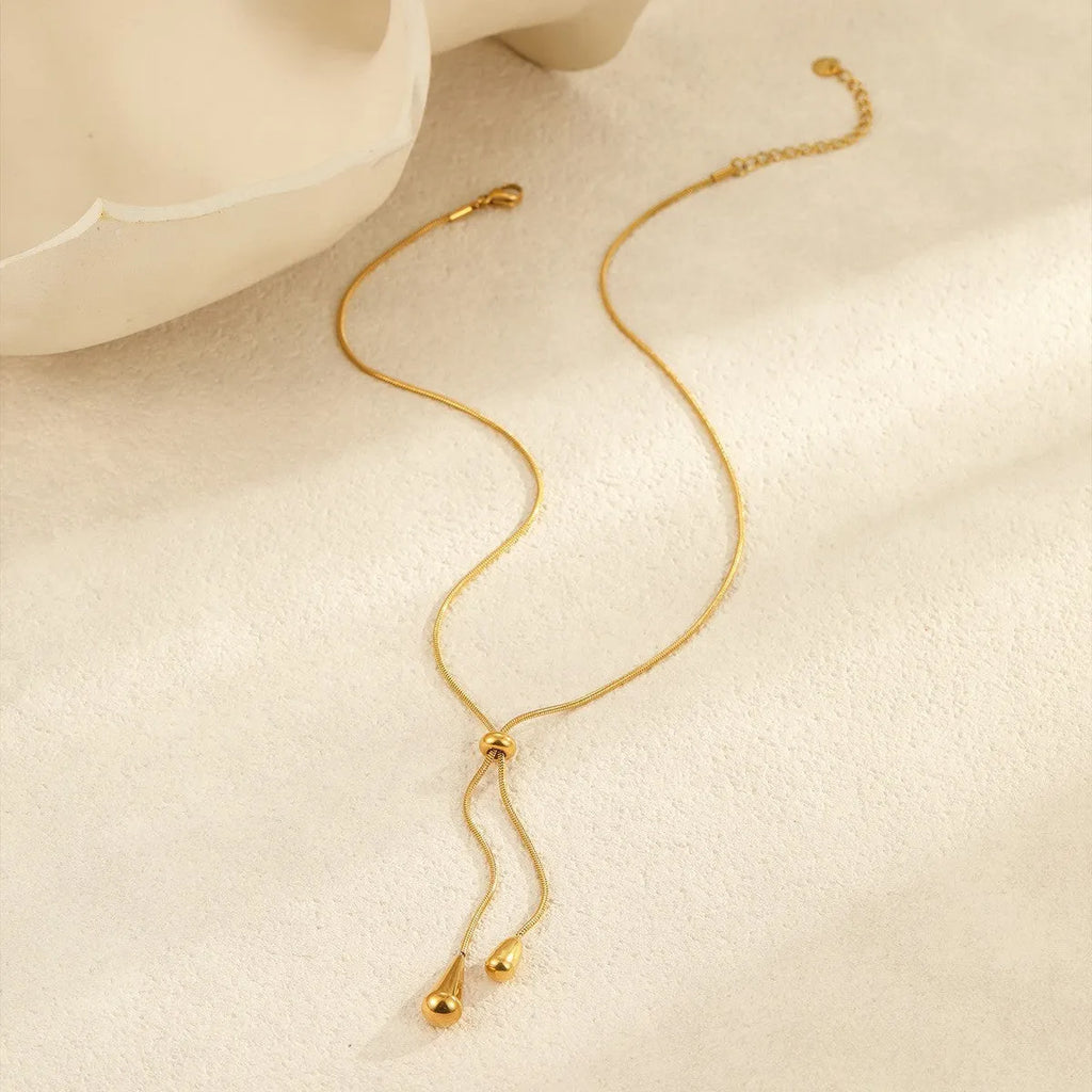Stainless steel tassel water drop earrings with Y-word chain ornament in 18K gold electroplated finish, geometric drop-shaped design