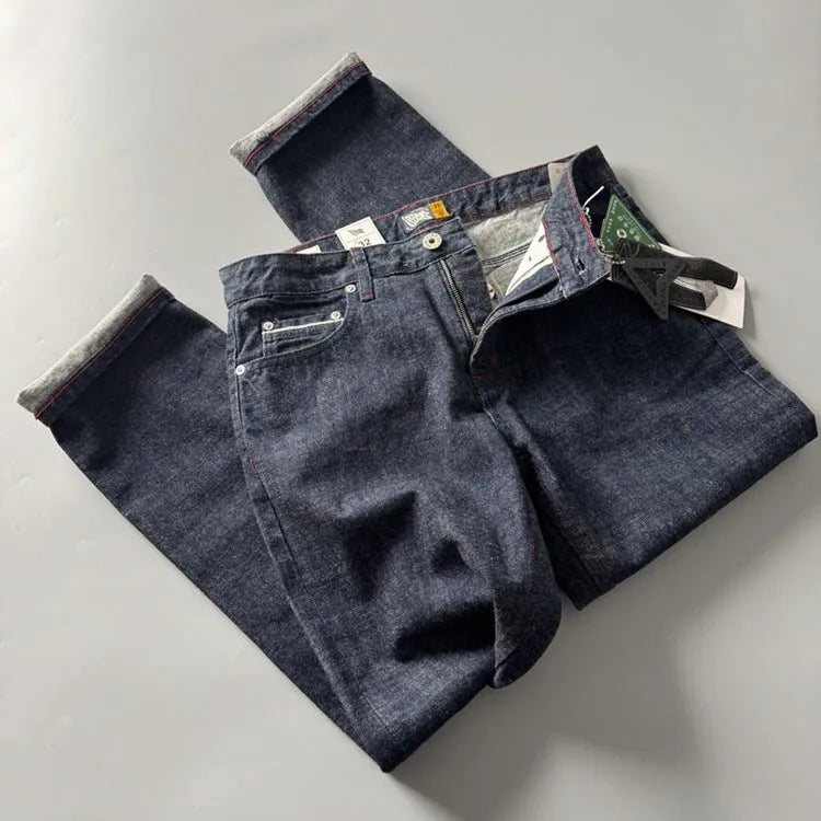 Men's primary colour straight leg denim jeans laid flat, showing mid waist and classic five-pocket design.