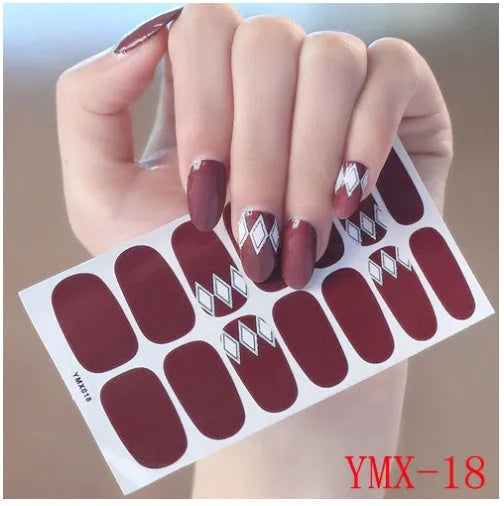 Full nail stickers set of 14 sheets showing 16 colour options in a flat lay arrangement
