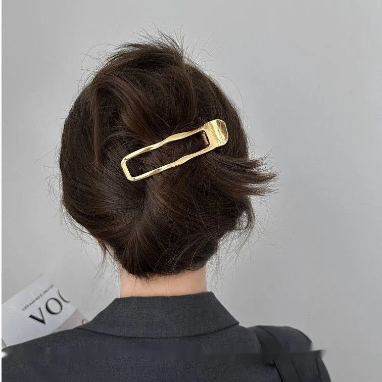 Gold and silver zinc alloy hair clip barrettes in arc, square, and triangle shapes.