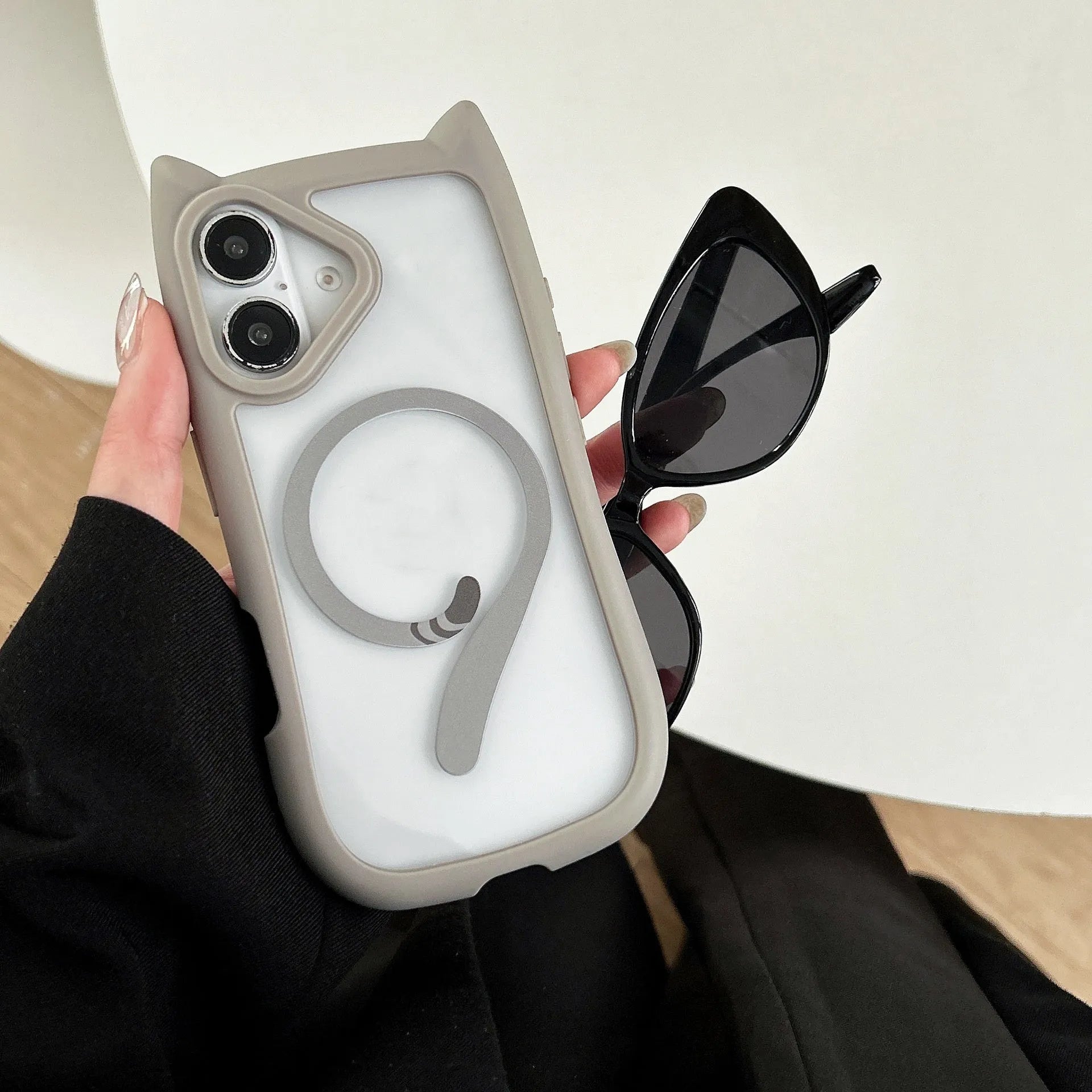 Transparent acrylic and TPU phone case for IPhone 17 with magnetic suction ring on back.