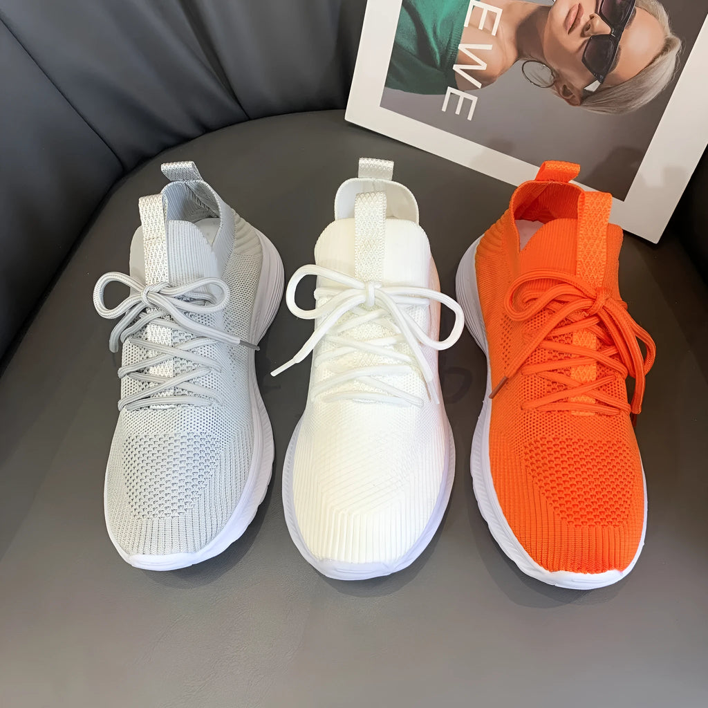 Women's low-top running shoes in Creamy White with mesh detailing and a flat rubber sole.