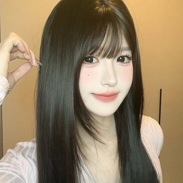 Dark brown long straight synthetic wig with bangs on wig head, showing full-head coverage