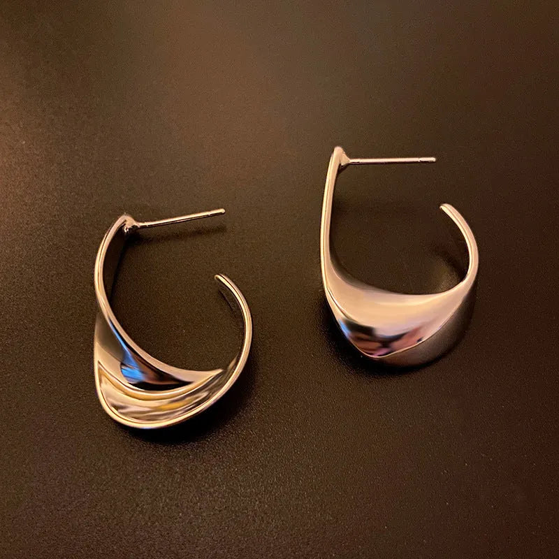 Twisted geometric metal hoop earrings in gold and silver electroplated colour options