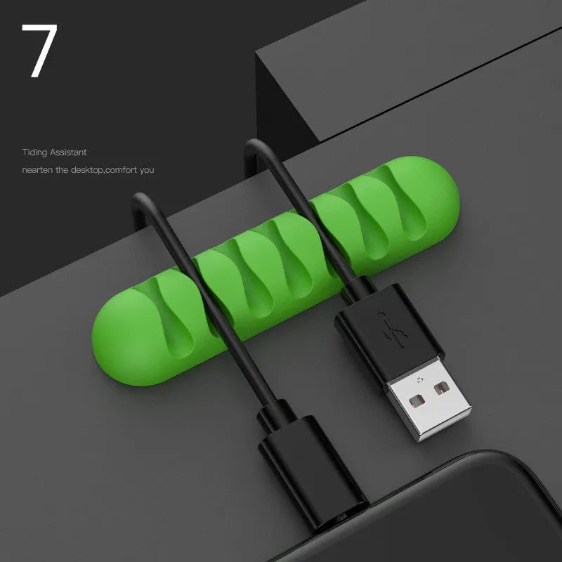 Smart cable holder with TPR flexible clips in black holding USB earphone and network cables on a desk