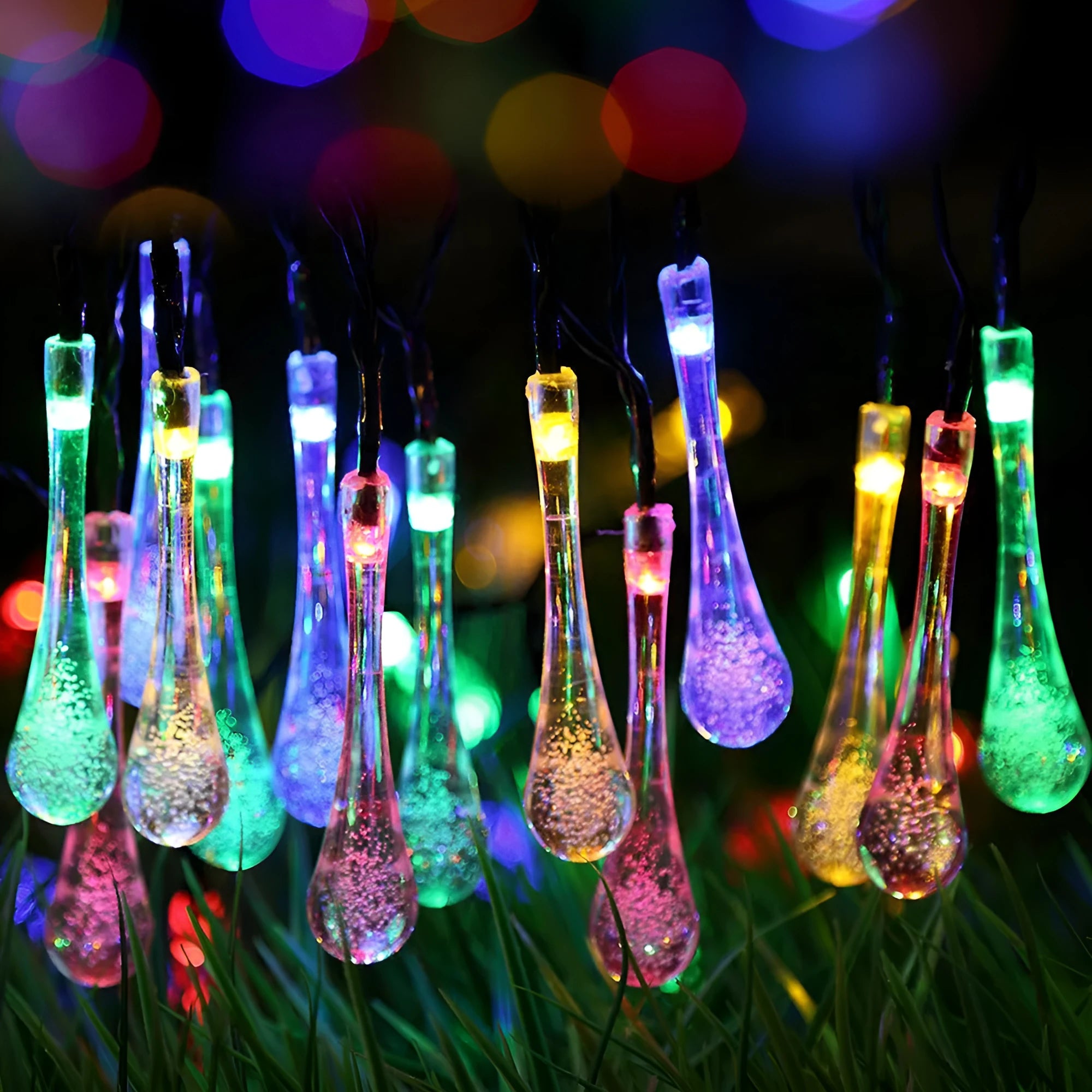 Solar-powered outdoor string lights with water drop shaped pendants on a 6.5 metre cable, shown with solar panel and ground spike.
