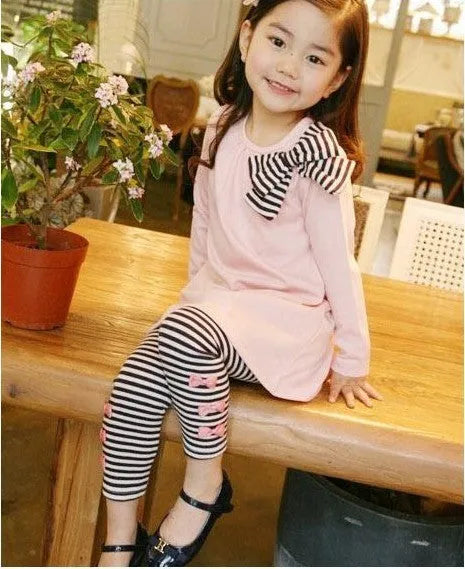 Pink cotton jersey knit clothing set for a girl, showing short-sleeved top and elasticated waist trousers.