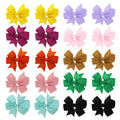 Assortment of multicoloured 3 inch grosgrain ribbon pinwheel hair bows with alligator clips for toddlers.