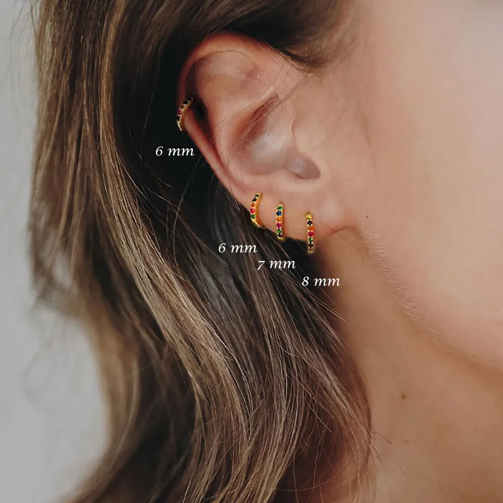 Circle zircon perforated stud earrings in gold, rose gold, and silver colour options with geometry round design