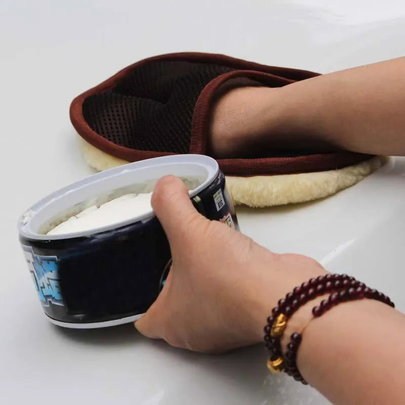 Pair of soft artificial wool car wash cleaning gloves in black, 15x24cm, on a car surface