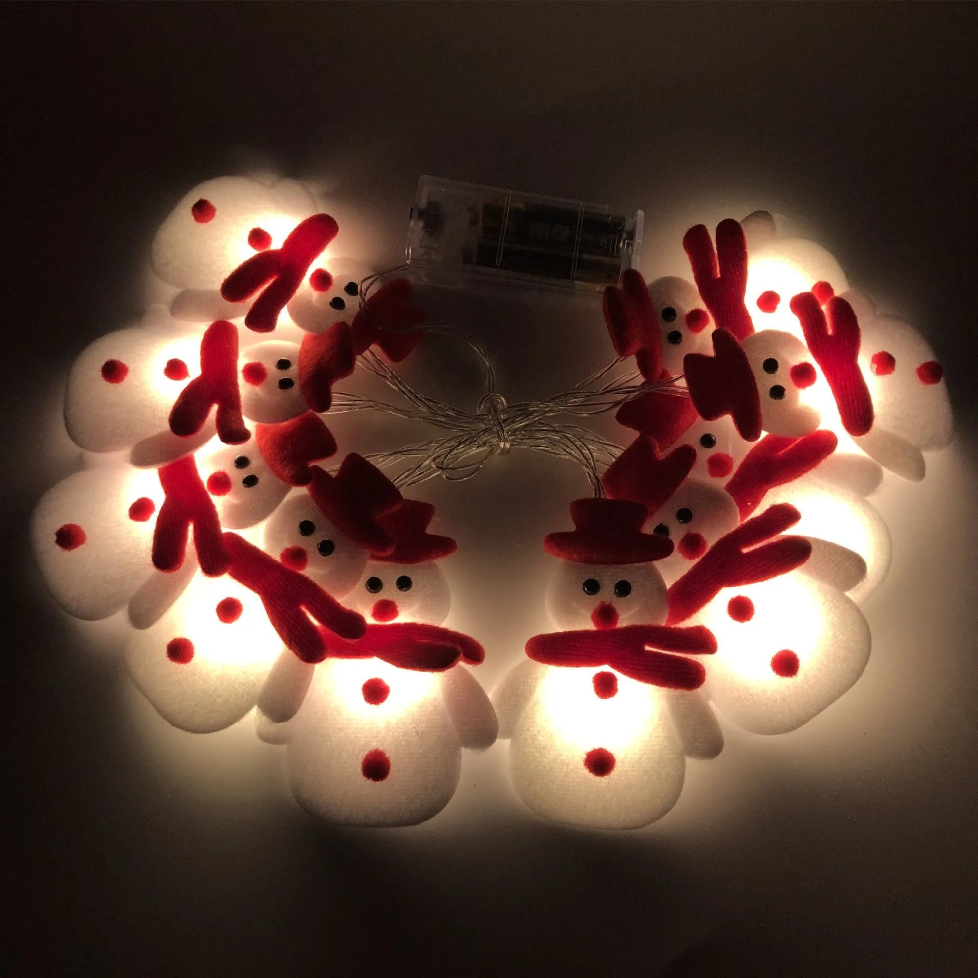 Warm white LED Christmas string lights with Snowman decorative figures on a green garland.